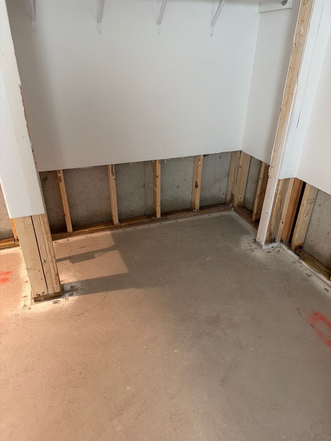 Closet with lower drywall removed after a flood cut