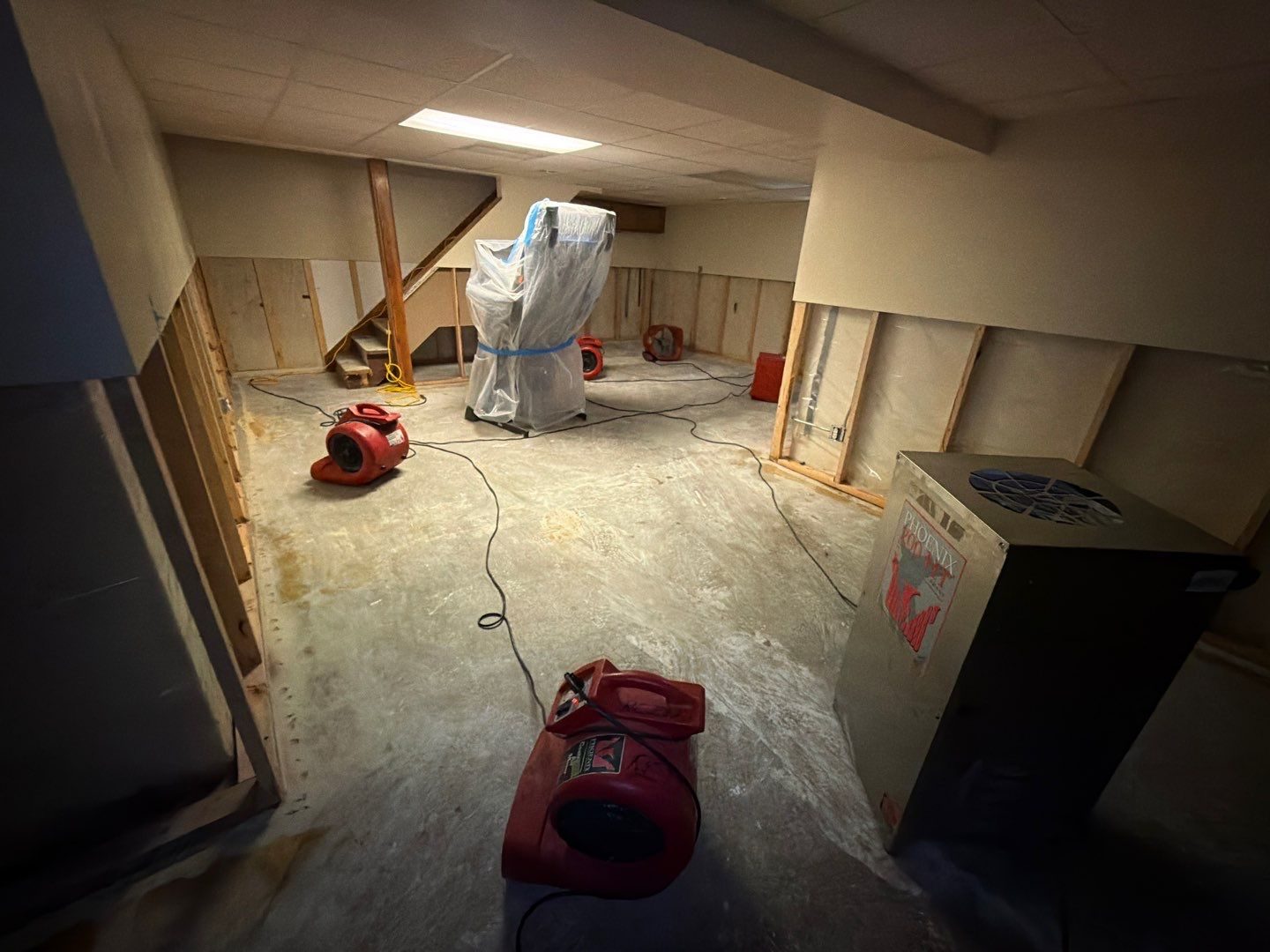 Basement drying setup with air movers and a dehumidifier